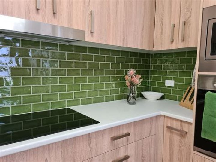 Can I put glass splashback on top of tiles?