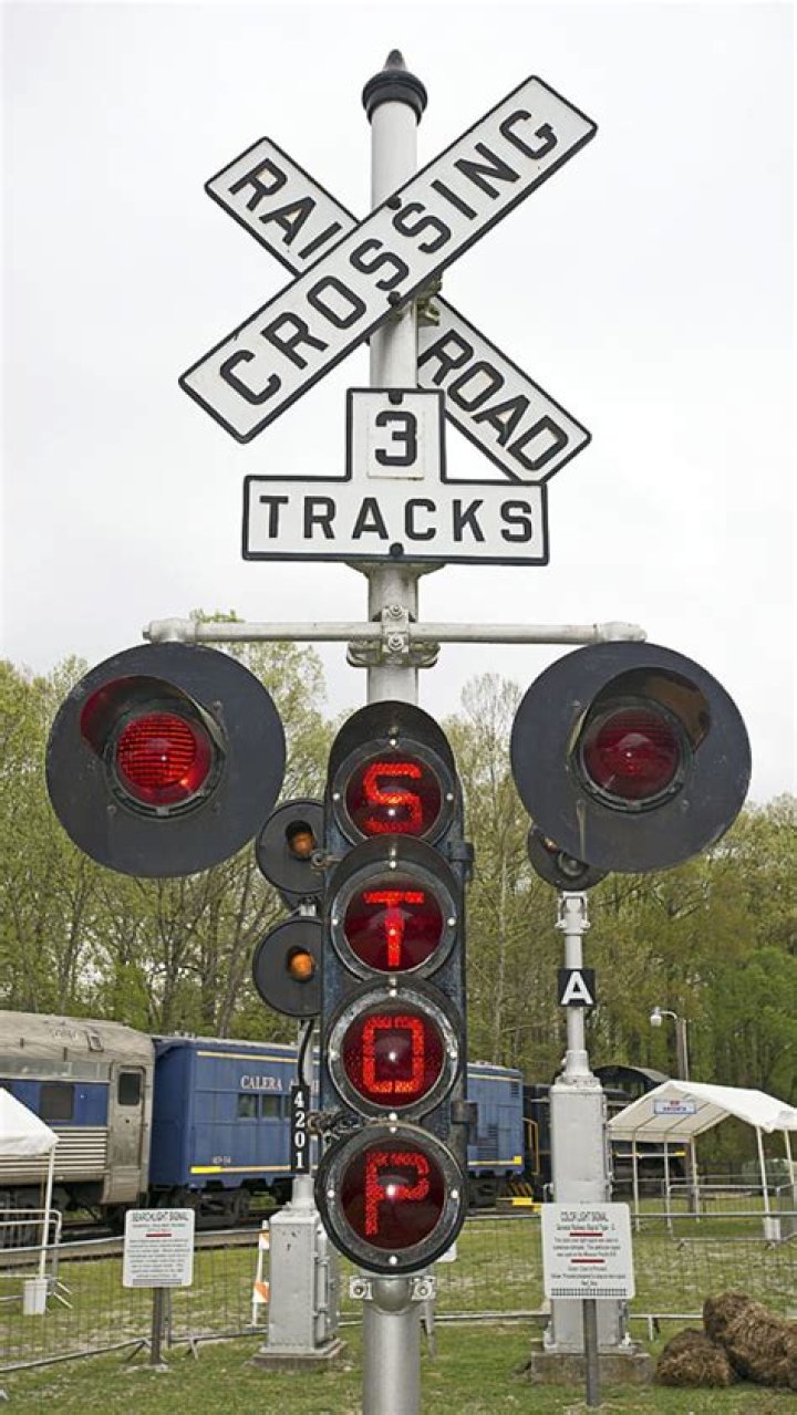 How are train crossing signals activated?