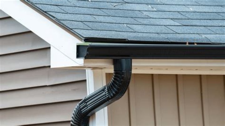 Where should gutter downspouts be placed?