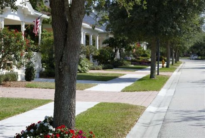 Who owns the grass between the sidewalk and the street